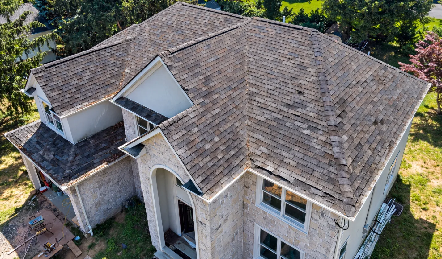 Before roofing project showing old worn asphalt shingles in Dallas, TX