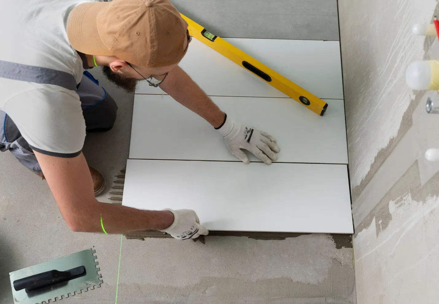 Bathroom remodeling contractor installing large format floor tiles during Dallas bathroom renovation