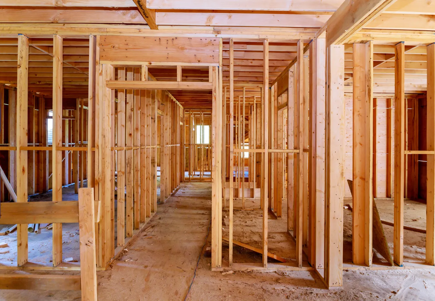 Residential framing construction showing interior wood studs structure during build phase in Dallas